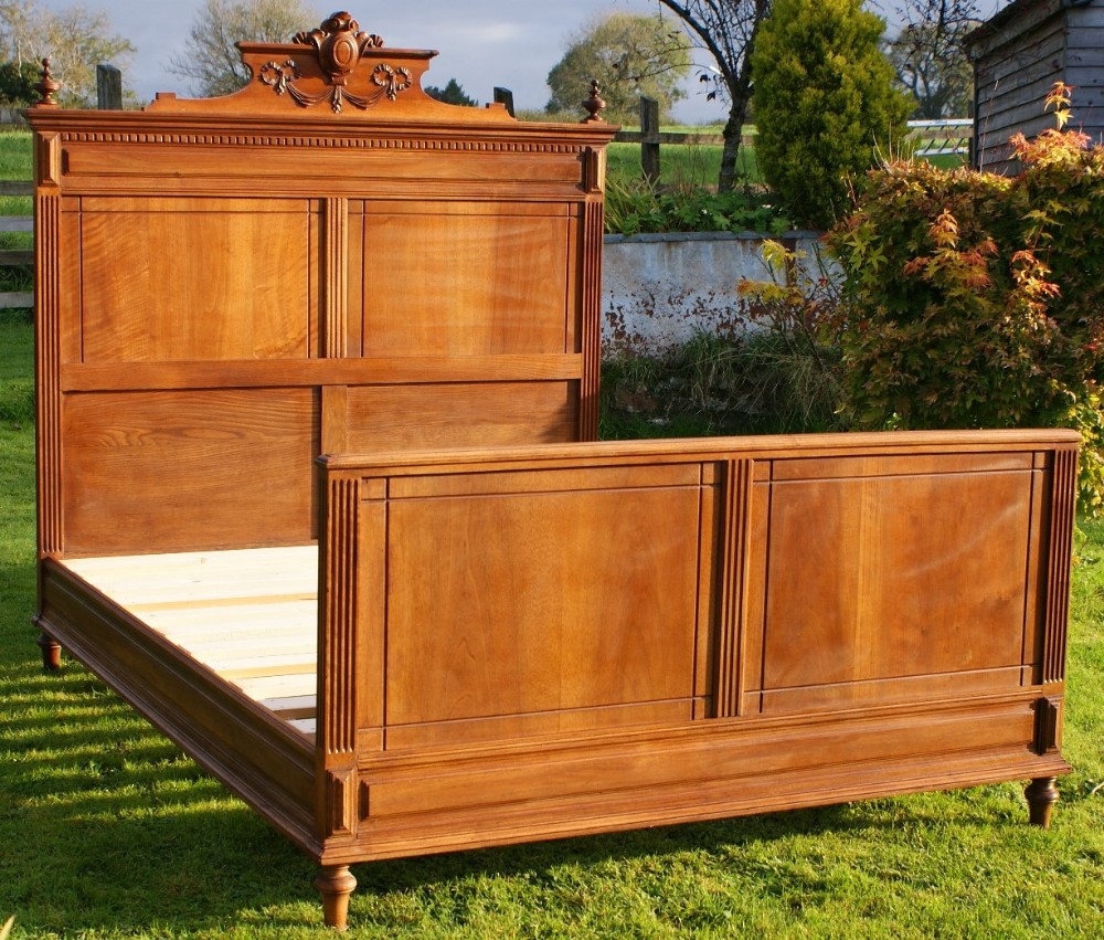 an late 19th century french solid walnut double bed with base